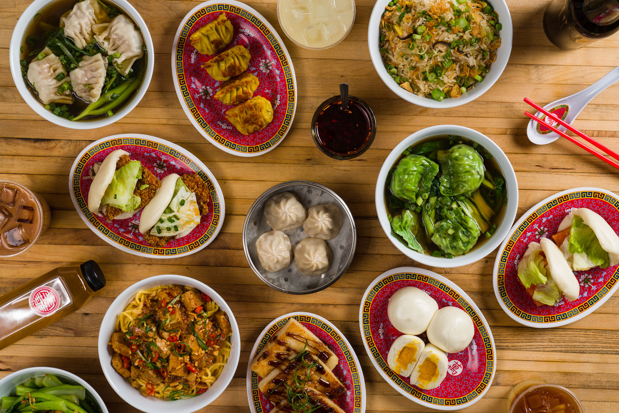 Spread of dishes from Nom Wah Nolita, including buns, dumplings, and noodles